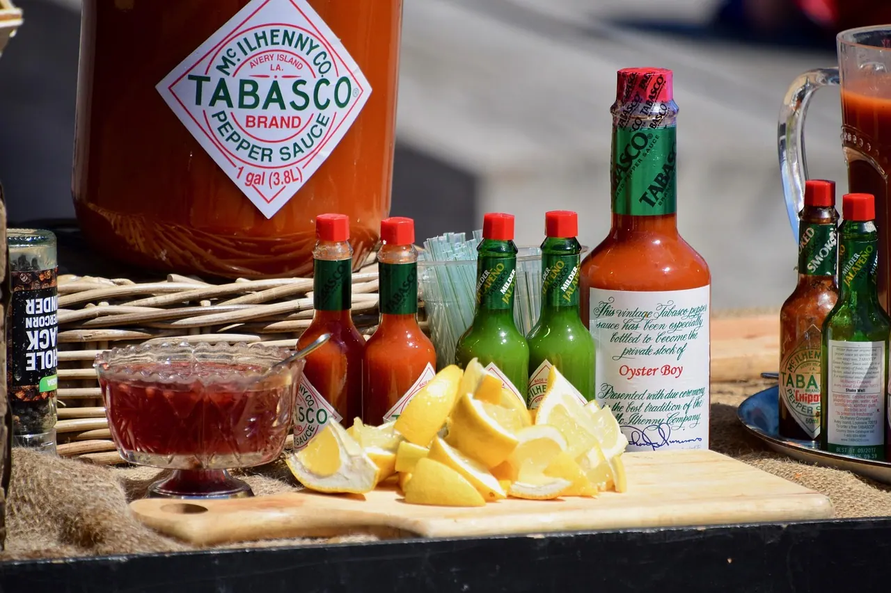 display table, food, food stall, lemon slices, lemons, food market, market stall, sauce, sauces, tabasco sauce, hot pepper sauce, outdoors, tabasco sauce, tabasco sauce, tabasco sa